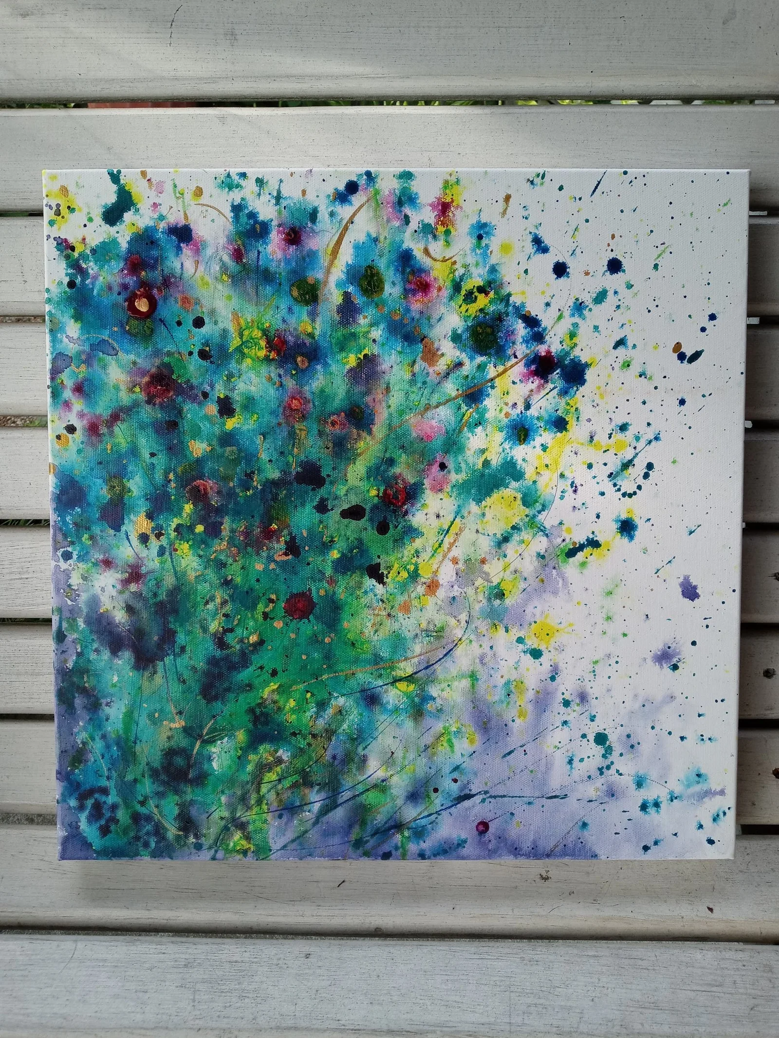 Square canvas dense with green, teal and violet splatter blooming from the left like wildflowers, scattered crimson and gold flecks across a white ground.